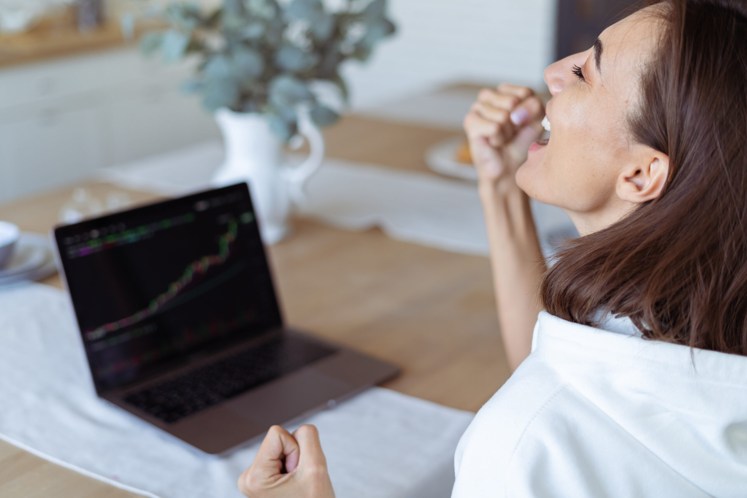 Woman looking at graph trending upwards